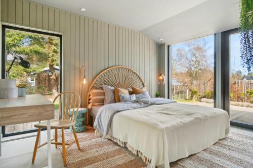 a bedroom with a large bed and a desk at Relaxed Lifestyle And Luxury In Melby in Melby