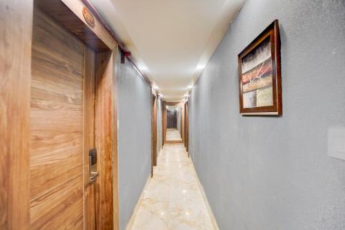 a long hallway with a door and a picture on the wall at Super Townhouse Prayagraj Central Bus Terminal Formerly Hotel Four View in Civil Lines