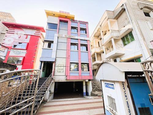 a building with colorful windows and stairs in a city at Aditi Residency New Digha Near Sea Beach in Digha