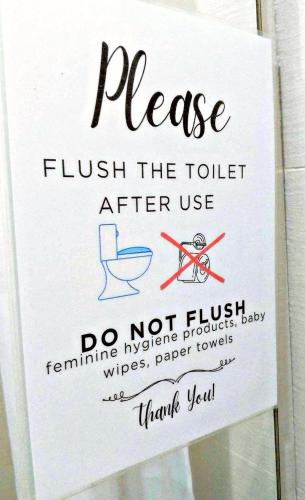 a sign that says please flush the toilet after use at Azure Staycationcation by Nairah in Manila