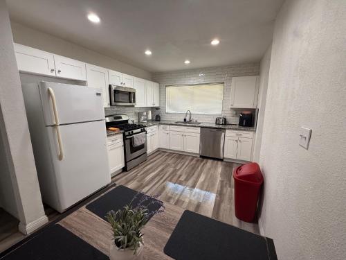 a kitchen with white cabinets and a white refrigerator at Las Vegas Great Location 2 Min to LV Strip in Las Vegas