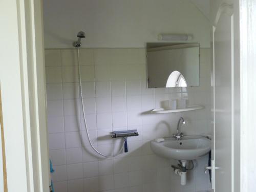 a bathroom with a sink and a shower at De Bekboer in Losser