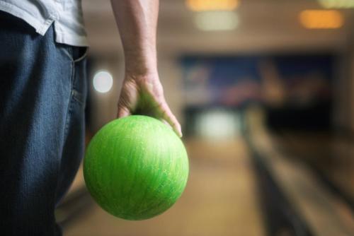 a person holding a green tennis ball in their hand at Sport-V-Hotel in Hrotovice
