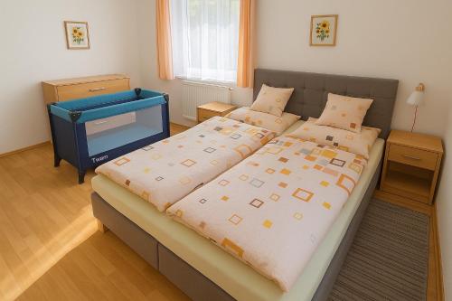 a bedroom with a large bed and a desk at Vila Šebest in Volary