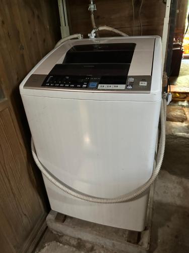 a white printer sitting in a corner of a room at 木古里ゲストハウス Kicoli guesthouse in Chizu