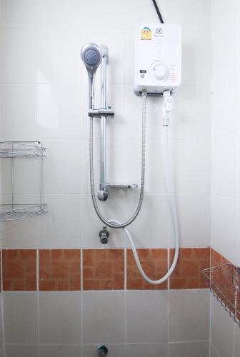a shower in a bathroom with a shower head at SCN City Hotel Rayong in Ban Chang
