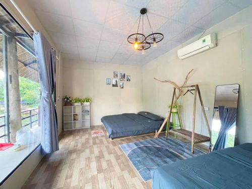 a bedroom with a bed and a chandelier at Z Camp Nha Trang in Nha Trang