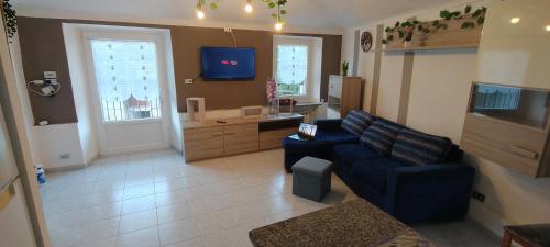 a living room with a couch and a tv at Cascina Babi in San Giuliano