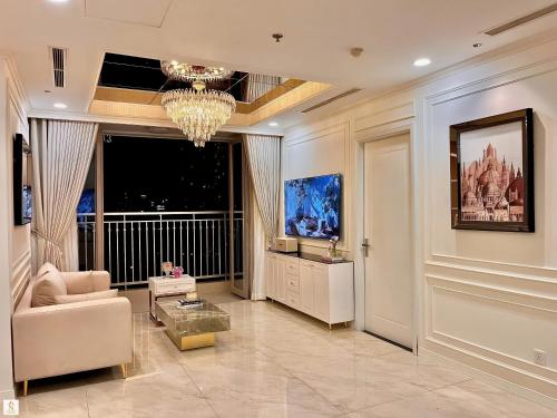 a living room with a chandelier and a couch and a table at The Peak Suite at Landmark Plus in Ho Chi Minh City