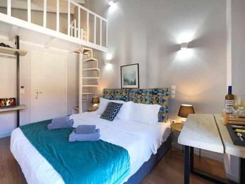 a bedroom with a large white bed and a staircase at Spa Guest House by White Hills in the Heart of Arachova in Arachova