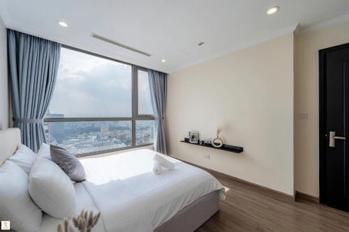 a bedroom with a bed and a large window at The Peak Suite at Landmark Plus in Ho Chi Minh City