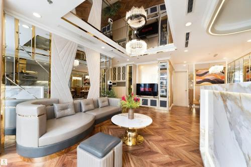 a living room with a couch and a table at The Peak Suite at Landmark Plus in Ho Chi Minh City