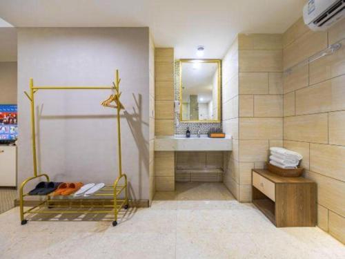 a bathroom with a sink and a mirror at Boke Boutique Hotel Shenzhen Longgang in Longgang