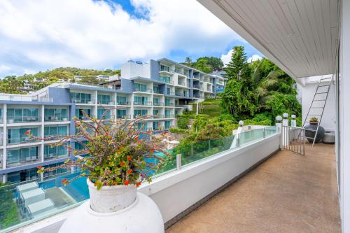 a balcony with a view of a building at Kata Hill Sea View Hotel in Kata Beach