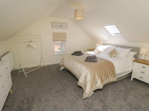 a bedroom with a bed and two windows at Coastal Corner in Whitby