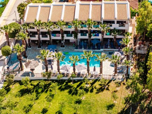 an aerial view of the resort with palm trees and a pool at Caretta Beach Resort & WaterPark in Kalamaki
