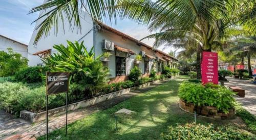a resort with a sign in front of a building at HON BA LAGI BEACH RESORT in La Gi