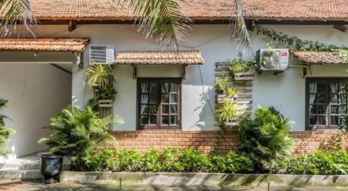 a house with plants in front of it at HON BA LAGI BEACH RESORT in La Gi