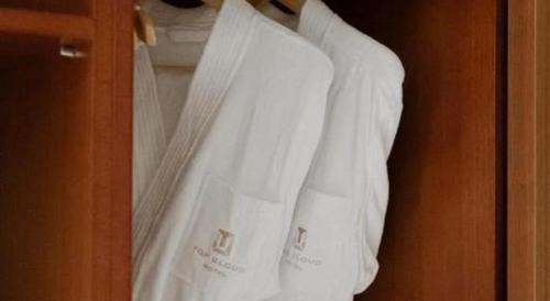 a closet with white sheets and pillows at Top Cloud Hotel Iksan in Iksan