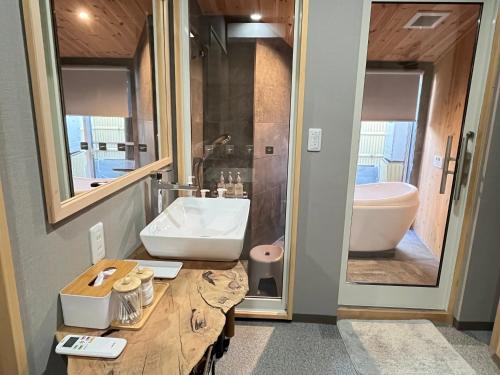a bathroom with a sink and a toilet and a mirror at 城下町小諸の古民家 - 町屋の隠れ宿-椛庵 Japanese old folk house - momijian in Komoro
