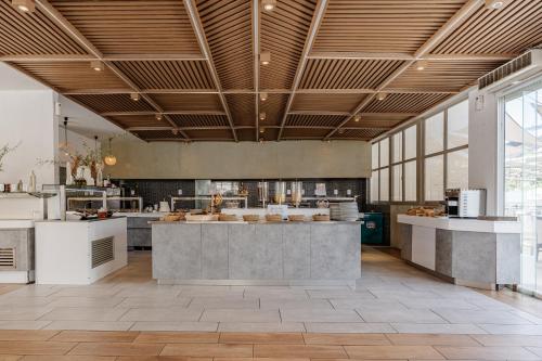 a large kitchen with a counter in the middle at Caretta Beach Resort & WaterPark in Kalamaki