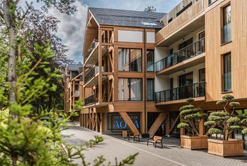 an apartment building with benches in front of it at Rezydencja Aqua SPA & Wellness by GRANO in Szklarska Poręba