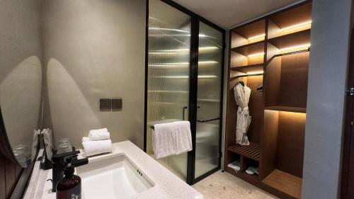 a bathroom with a sink and a bath tub at Hygge Hotel and Villas Seminyak in Seminyak