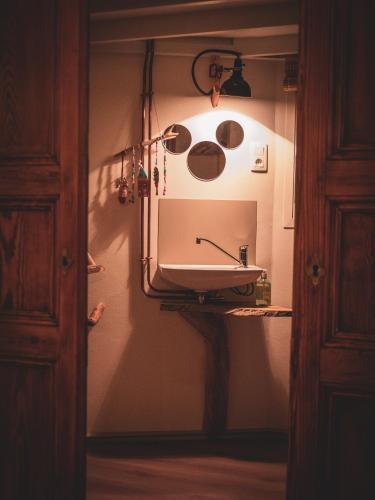 a bathroom with a sink and a mirror at L'Échappée des Collines - Tiny House in Frasnes-lez-Anvaing