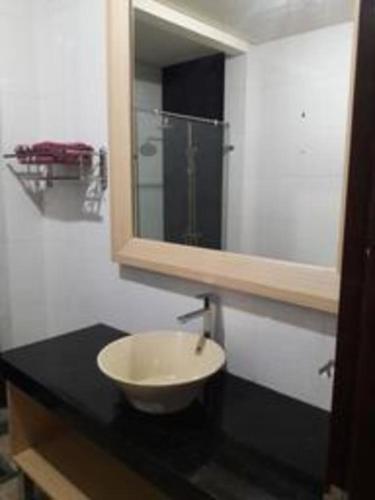 a bathroom with a sink and a mirror at Fafa Hill Hotel and Resort in Bogor