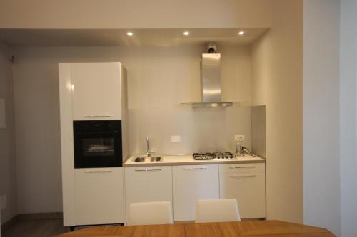 a kitchen with white cabinets and a sink and a stove at Ca' da Valeria One in Chiavari