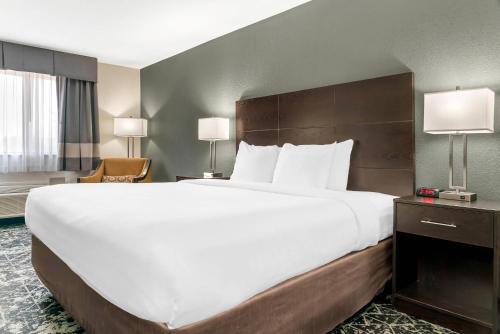 a large white bed in a hotel room at Quality Inn Grand Rapids South-Byron Center in Grand Rapids