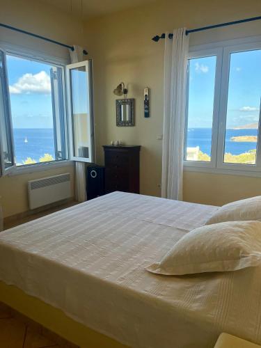 a bedroom with a bed with a view of the ocean at Villa Natasa in Batsi
