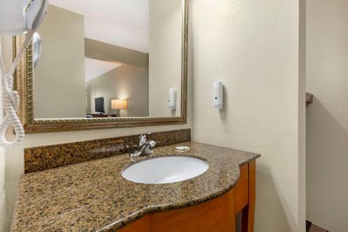 a bathroom with a sink and a mirror at Quality Inn Lumberton North in Lumberton