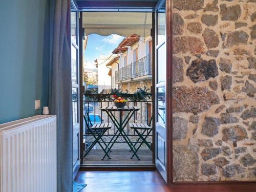 a glass door leading to a balcony with a table at Spa Guest House by White Hills in the Heart of Arachova in Arachova