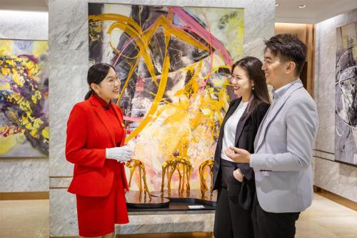 a group of people standing in front of a painting at Kempinski Hotel Khan Palace in Ulaanbaatar