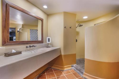 a bathroom with a large sink and a mirror at Hilton Grand Vacations Club Zihuatanejo in Zihuatanejo