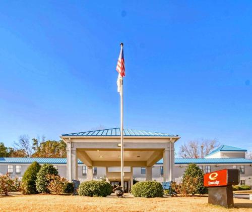 a flag on a pole in front of a building at Econo Lodge Raleigh near Walnut Creek Amphitheatre in Raleigh