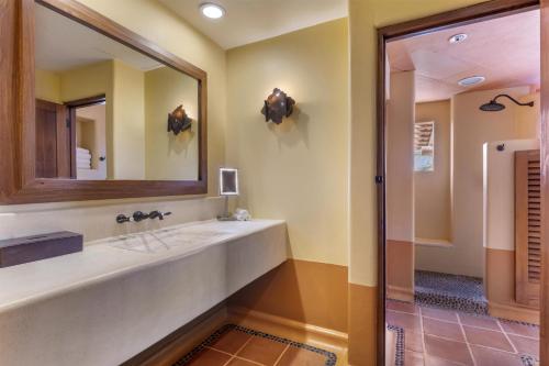 a bathroom with a sink and a mirror at Hilton Grand Vacations Club Zihuatanejo in Zihuatanejo