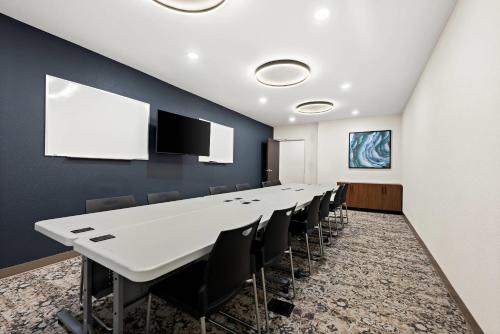 a conference room with a long table and chairs at Everhome Suites Huntsville - Research Park in Huntsville