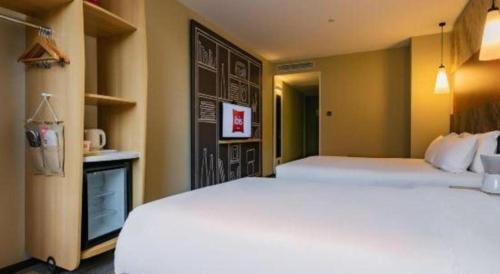 a hotel room with two beds and a kitchen at ibis xian North Second Ring Weiyang Rd Hotel in Xi'an