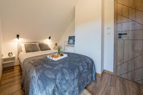 a bedroom with a bed and a dresser at Dunajec Spa House in Tylmanowa