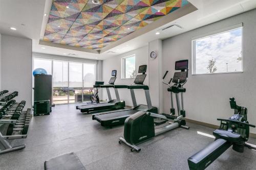 a gym with several treadmills and a colorful ceiling at Home2 Suites by Hilton Coppell DFW Grapevine North in Coppell