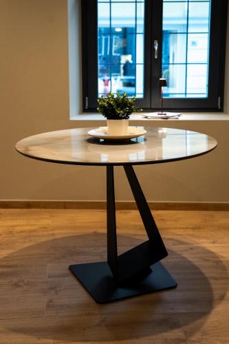 a table with a potted plant sitting on top of it at KODERLE SUITE K1 Bucaneve in Brunico