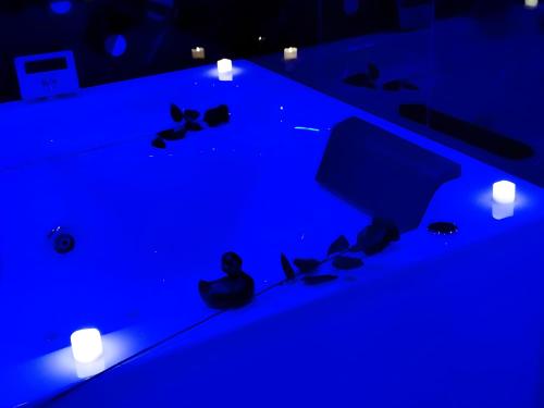 a blue pool table with butterflies on it at Love Room, Gîte 4 étoiles, 50 Nuances Romantiques in Villeneuve-en-Retz