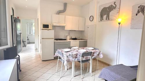 a kitchen with a table with a table cloth on it at la casetta di Ponente in San Bartolomeo al Mare
