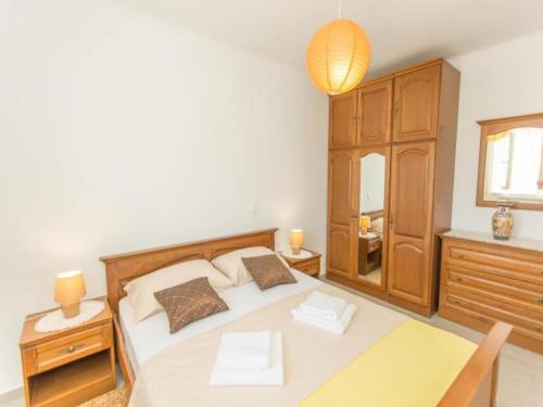 a bedroom with a bed and a table and a lamp at Apartment Moja - Two Bedroom Apartment with Terrace in Zaton Doli