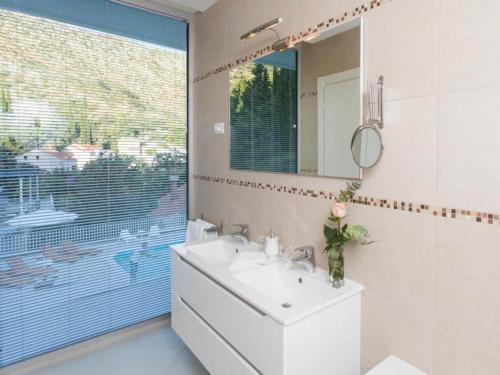a bathroom with a sink and a mirror at Five Bedroom Villa with Private Pool & Sea View in Zaton