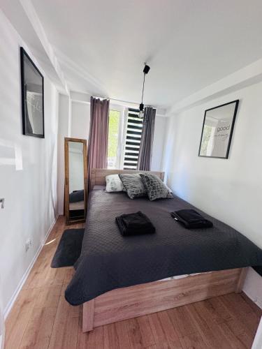 a bedroom with a large bed and a large window at Apartament Świdnik Kosik in Świdnik