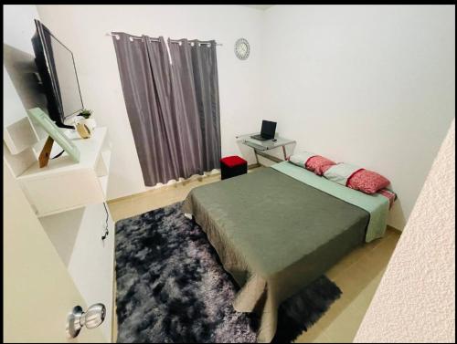 a bedroom with a bed and a television in it at Casa Real Segovia in Huejotzingo