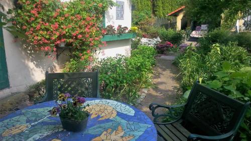 a table and chairs with a table and flowers at Słoneczne apartamenty in Sobótka